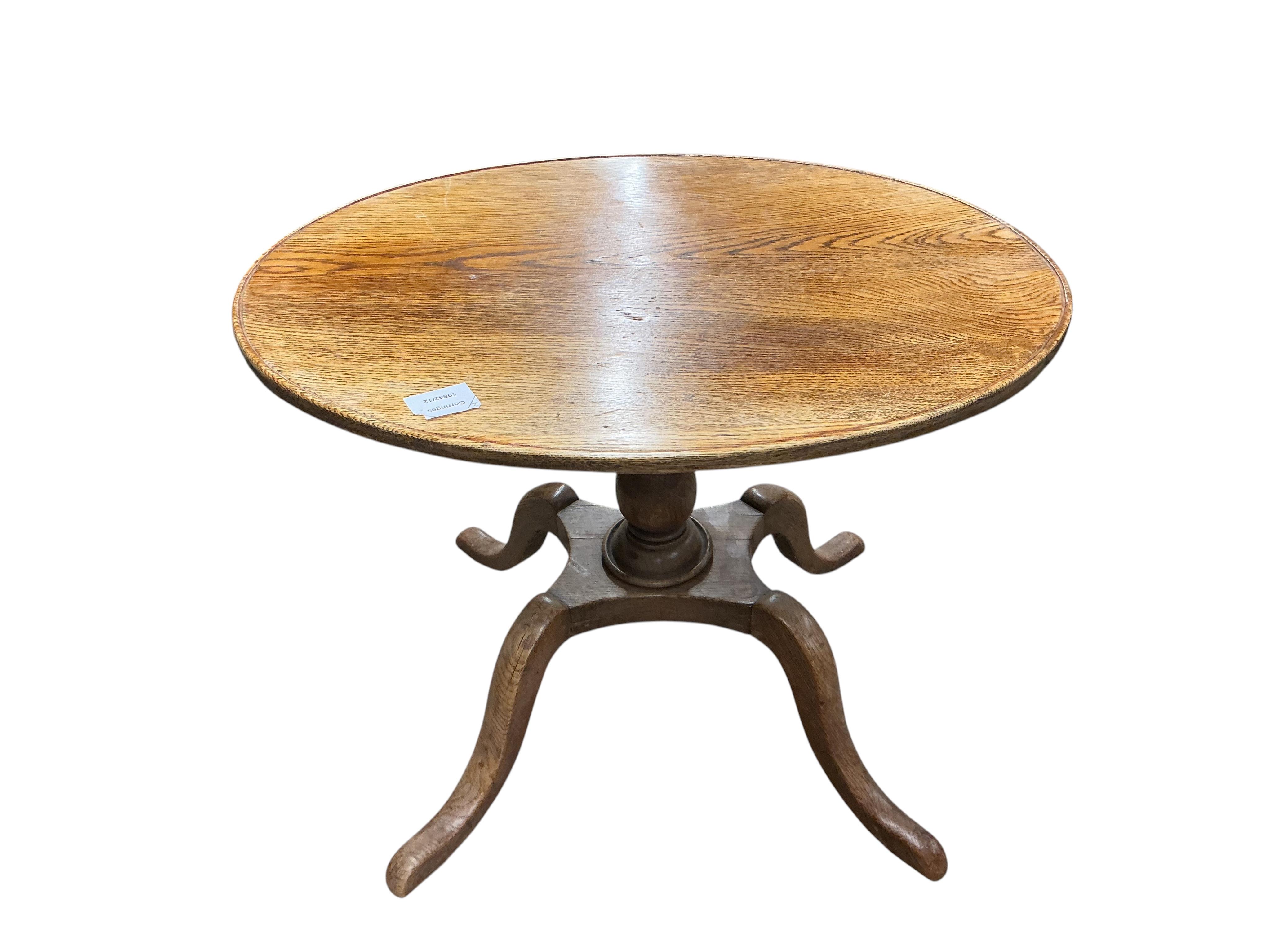 An early 19th century circular mahogany tilt top tripod tea table, diameter 59cm, height 71cm, together with an oak oval occasional table, adapted